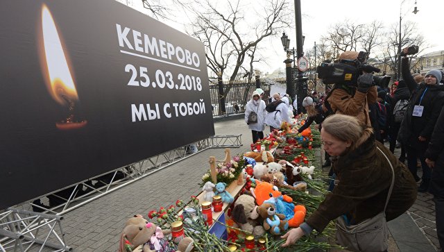 Москвичи несут цветы и игрушки к месту скорби о жертвах пожара в Кемерово