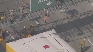 Man back-flips to safety from a highway sign, gets arrested